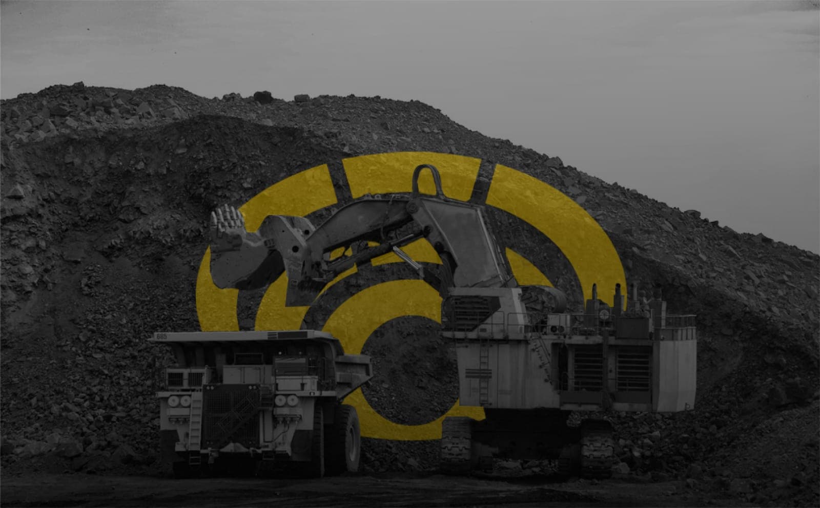 Large excavator and haul truck at a mine with a yellow Wi-Fi signal icon overlay.